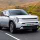 Kia EV9 review (2024): front three quarter tracking, silver paint, British country road