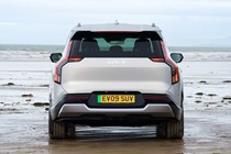 Kia EV9 review (2024): rear static, silver paint, parked on a beach