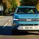 Dacia Spring review - dead-on front, blue, driving in the UK