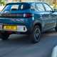 Dacia Spring review - rear view, blue, driving in the UK