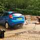 Paula Cullington tests a pressure washer on a blue car.