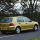 Volkswagen Golf Mk4 review: rear three quarter driving, gold paint, wood in background
