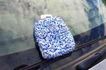 Gyeon wash mitt resting on car windscreen