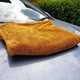 Drying towel on bonnet of Volvo