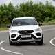 Cupra Ateca review - facelift, front view, white, driving round corner