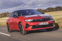Vauxhall Astra Sports Tourer Electric (2023) review: front driving, British country lane, red paint