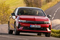 Vauxhall Astra Sports Tourer Electric (2023) review: front three quarter cornering, British country lane, red paint