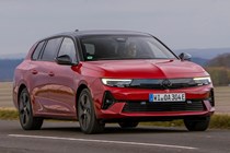 Vauxhall Astra Sports Tourer Electric (2023) review: front three quarter driving, close-up, British country lane, red paint