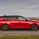 Vauxhall Astra Sports Tourer Electric (2023) review: side view pan shot, British country lane, red paint