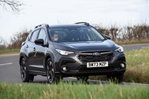 Subaru Crosstrek review (2024): front three quarter cornering, grey paint, British country road