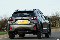 Subaru Crosstrek review (2024): rear three quarter cornering, grey paint, British country road
