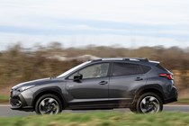 Subaru Crosstrek review (2024): side view driving, passenger's side, grey paint, British country road