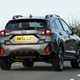 Subaru Crosstrek review (2024): rear three quarter cornering, showing body roll, grey paint, British country road