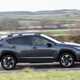 Subaru Crosstrek review (2024): side view driving, driver's side, grey paint, British country road