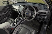 Subaru Crosstrek review (2024): driver's seat and steering wheel, black upholstery