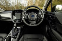 Subaru Crosstrek review (2024): steering wheel and infotainment system, black upholstery