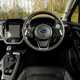 Subaru Crosstrek review (2024): steering wheel and infotainment system, black upholstery