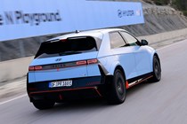 Hyundai Ioniq 5 N (2024) review: rear three quarter driving, on track, matte blue paint, Spanish roads
