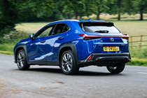 Lexus UX300h (2024) rear three quarters driving