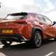 Lexus UX review, rear view, orange, driving