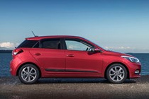 Hyundai i20 Hatchback (2015-) - UK rhd in red model, static exterior side-on profile Premium Nav 