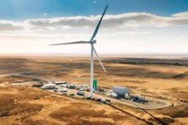 The future of fuel: Porsche eFuel plant in Chile, wind turbine and factory buildings
