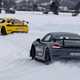 The future of fuel: Porsche Cayman prototypes running on eFuel, drifting around a corner on an ice racing circuit, grey and yellow paint