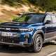 The best hybrid SUVs in 2025: Dacia Bigster, front three quarter driving, blue paint