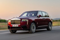 Rolls-Royce Cullinan (2024) review: front three quarter driving, red paint