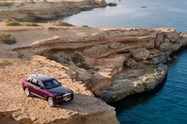 Rolls-Royce Cullinan (2024) review: front three quarter static, on top of a mountain, purple paint