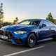 Mercedes-AMG CLE 53 review: front three quarter driving, low angle, sunset lighting, blue paint