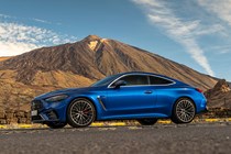 Mercedes-AMG CLE 53 review: front three quarter static, low angle, mountain in background, blue paint