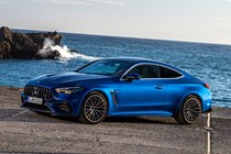 Mercedes-AMG CLE 53 review: front three quarter static, ocean in background, blue paint
