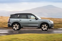 MINI Countryman (2024) review: side view driving, silver paint, British country road
