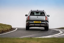 MINI Countryman (2024) review: rear three quarter cornering, silver paint, British country road