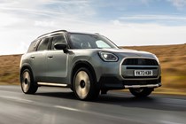 MINI Countryman (2024) review: front three quarter driving, low angle silver paint, British country road