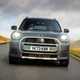 MINI Countryman (2024) review: front driving, low angle, silver paint, British country road