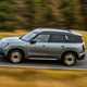 MINI Countryman (2024) review: side view driving, high angle, silver paint, British country road