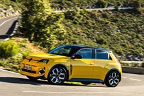 Renault 5 E-Tech review on Parkers.co.uk - yellow, front, driving round corner