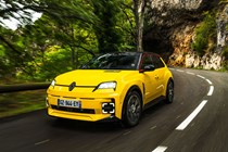 Renault 5 E-Tech (2024) review: front three quarter driving, low angle, yellow paint