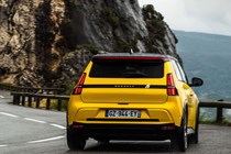 Renault 5 E-Tech (2024) review: rear three quarter cornering, low angle, yellow paint