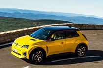 Renault 5 E-Tech (2024) review: front three quarter cornering, mountain road yellow paint