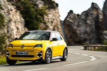 Renault 5 E-Tech (2024) review: front three quarter cornering, through a valley, yellow paint