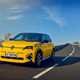 Renault 5 E-Tech (2024) review: front three quarter driving, offset angle, yellow paint, sunny