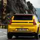 Renault 5 E-Tech (2024) review: rear three quarter cornering, low angle, yellow paint