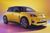 Renault 5 E-Tech Electric (2025): front three quarter static, low angle, yellow paint, studio shoot