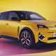 Renault 5 E-Tech Electric (2025): front three quarter static, low angle, yellow paint, studio shoot