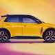 Renault 5 E-Tech Electric (2025): front side static, yellow paint, studio shoot