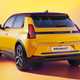 Renault 5 E-Tech Electric (2025): rear three quarter static, low angle, yellow paint, studio shoot