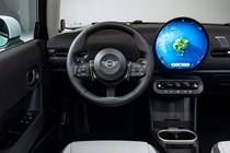 MINI Cooper (2024): steering wheel and infotainment system, black and grey upholstery